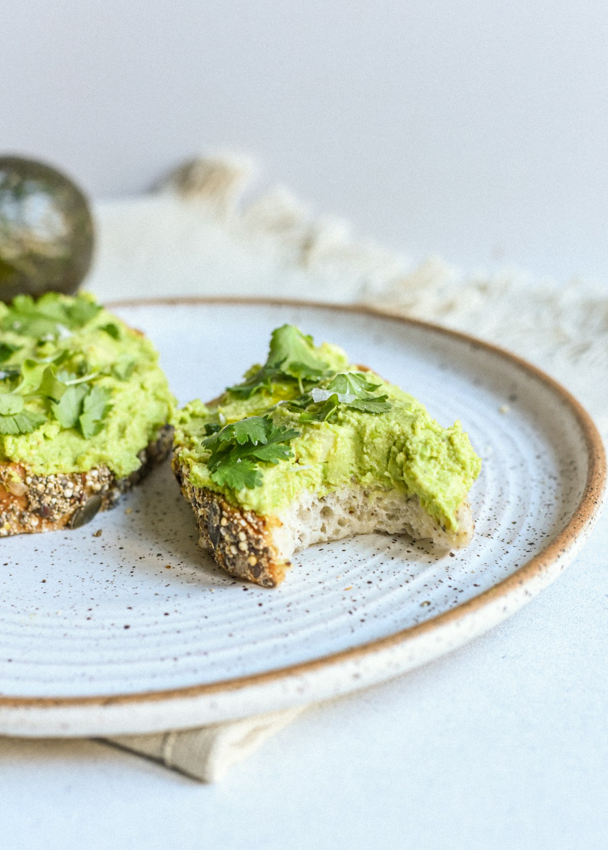 Smashed avocado on seeded sourdough toast scattered with coriander