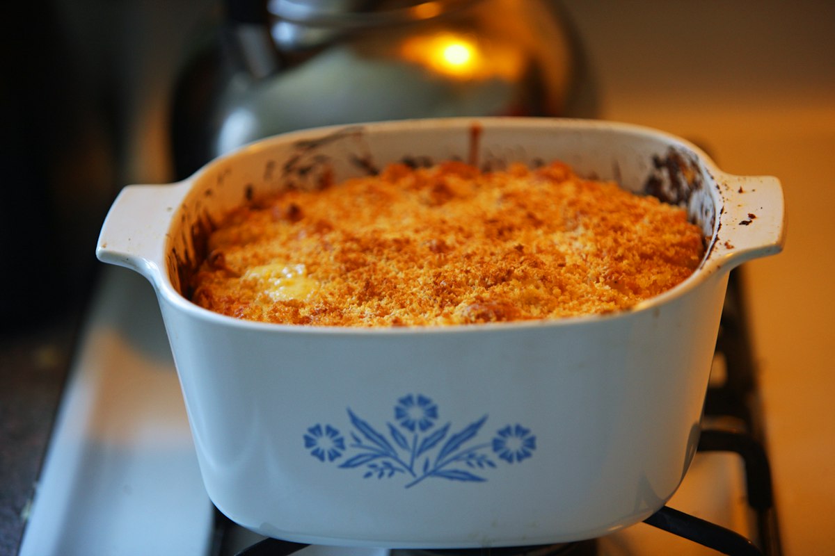 Macaroni cheese baked with a golden breadcrumb crust in a casserole dish