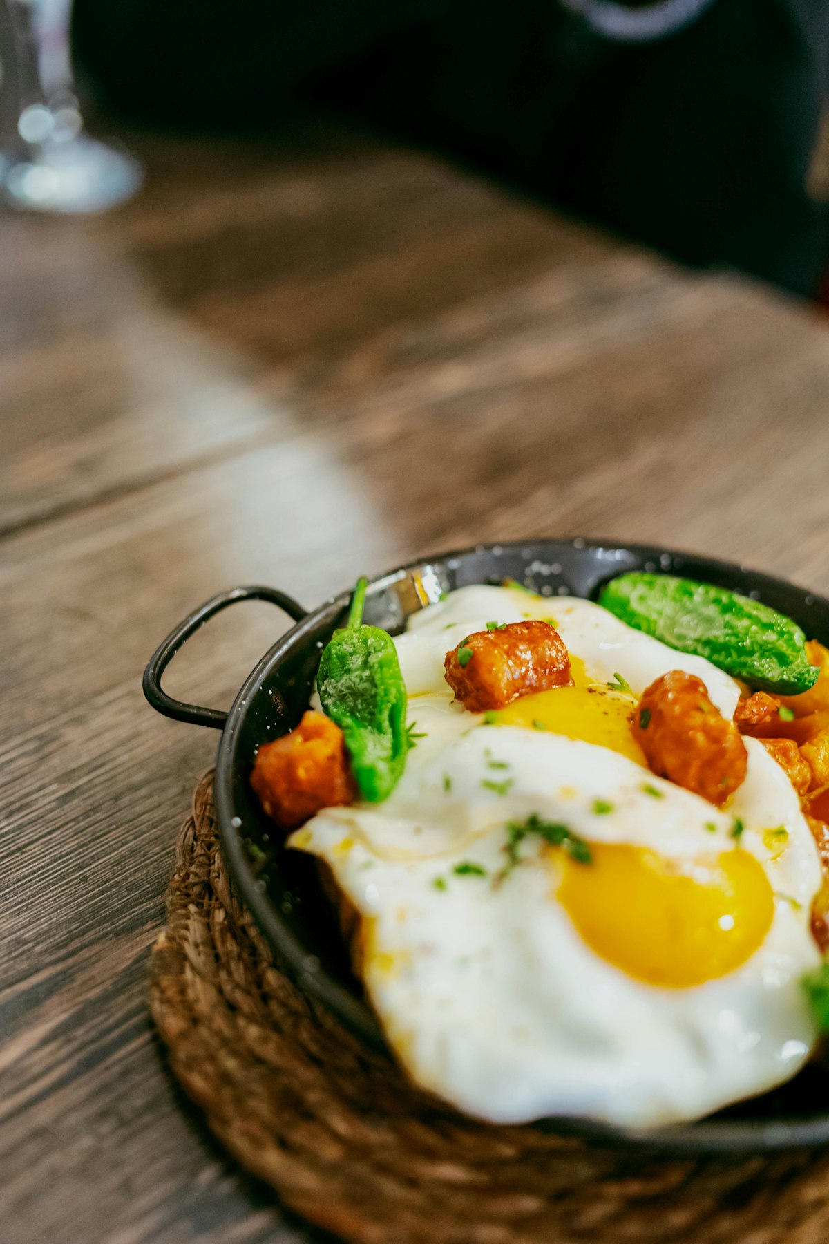 A skillet of sweet potato hash with chorizo, peppers and fried eggs