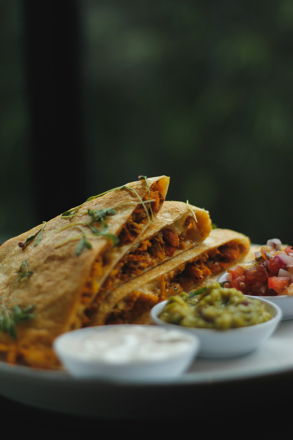 Crisp quesadilla wedges served with salsa, guacamole and sour cream