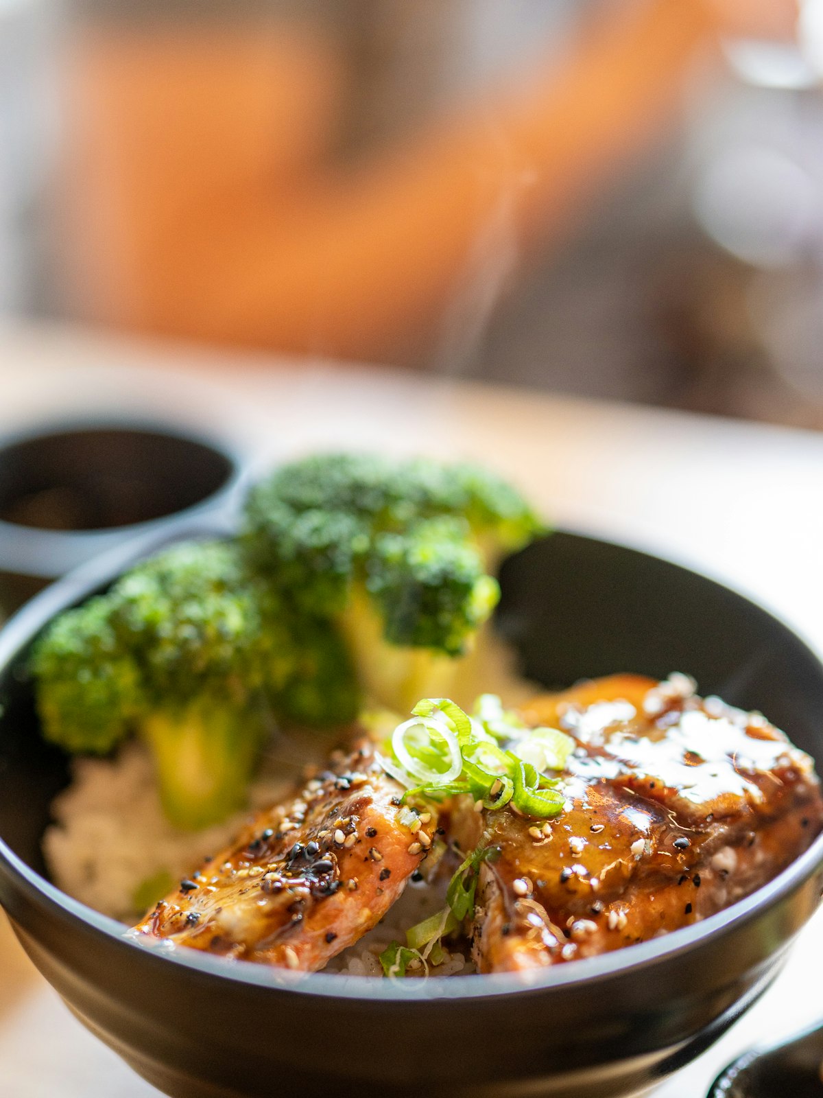 Glazed honey soy chicken with sesame seeds, spring onion and broccoli