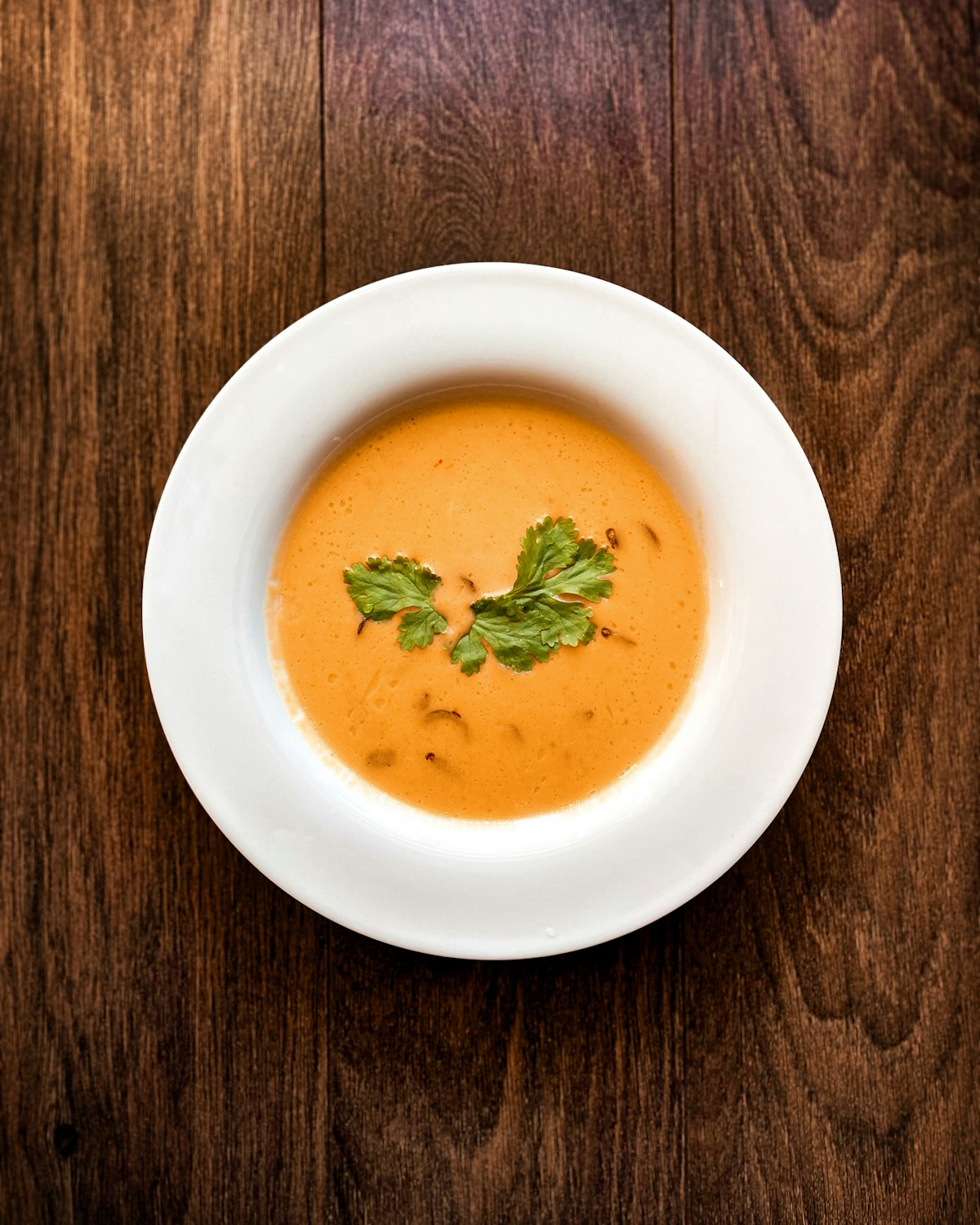 A bowl of creamy lentil soup finished with fresh coriander