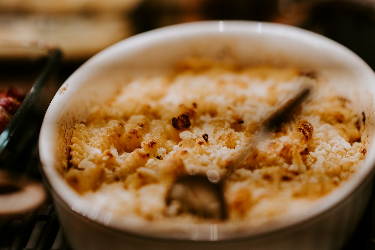 A bowl of creamy baked rice pudding with a spoon