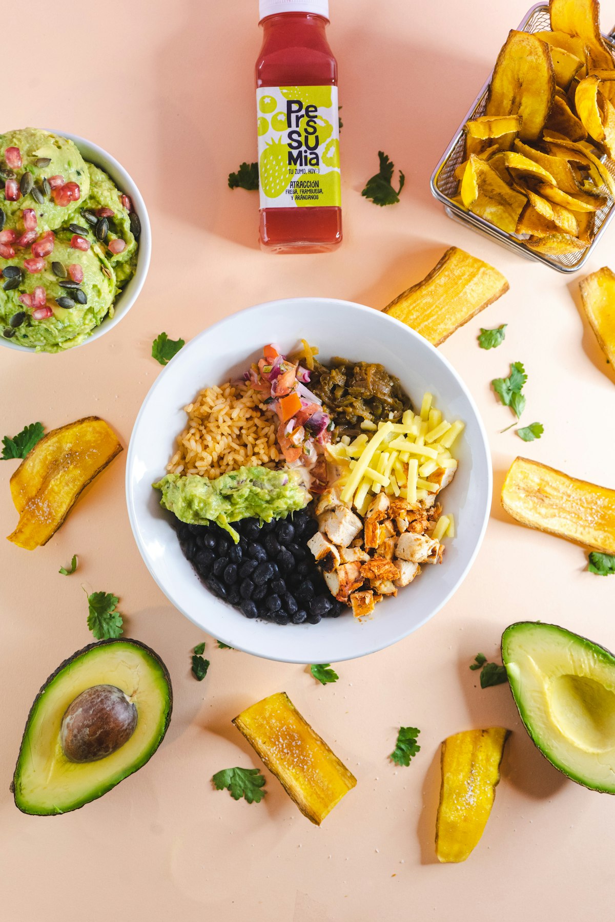 A taco rice bowl with black beans, chicken, guacamole and pico de gallo